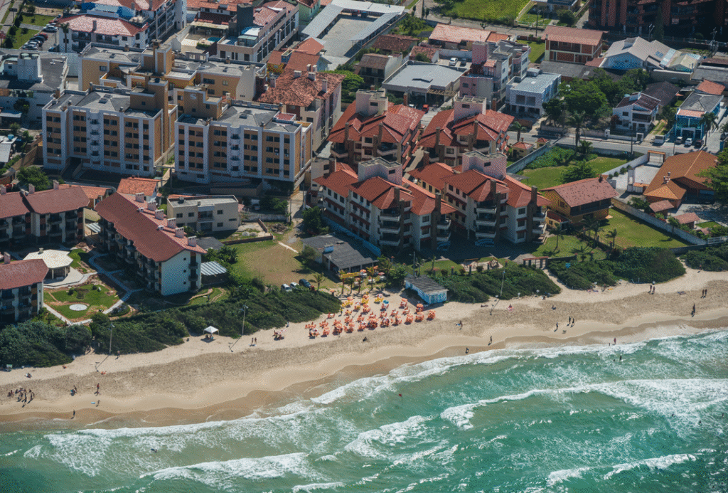 Beachfront apartments and residential neighborhoods in Florianópolis, Brazil, showing coastal real estate and housing developments.
