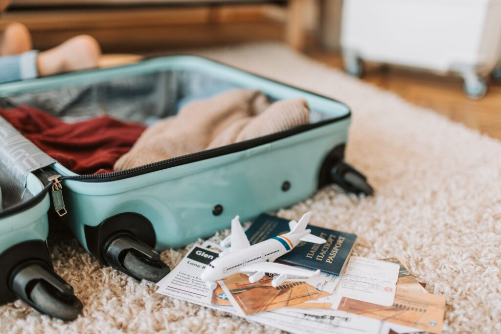 Packed suitcase, passport, and travel documents symbolizing international relocation and the excitement of moving abroad to a new country