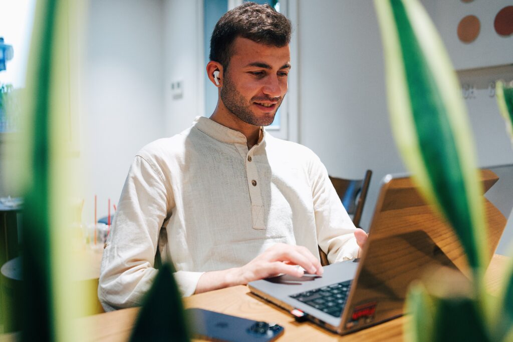 A professional working on a laptop from home, representing the Pareto Principle by focusing on high-impact tasks that drive productivity and success.