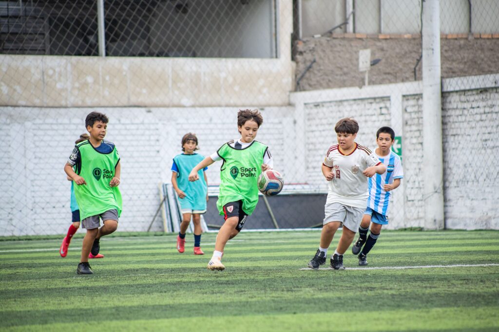 Children playing football at a local sports club, helping kids build friendships after moving abroad