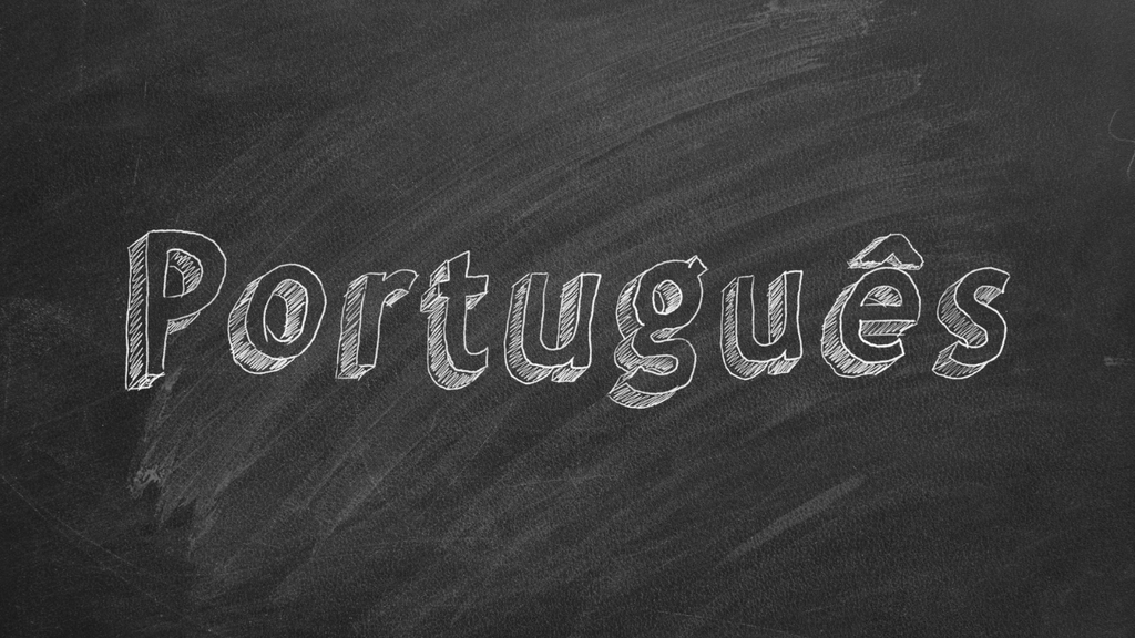 Portuguese written in white chalk on a dark blackboard with a textured, hand-drawn lettering style.